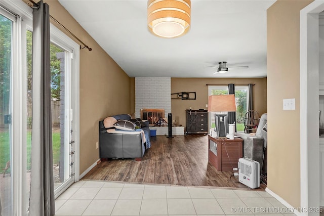 7630 E 54th Pl, Tulsa, OK 74145 - living area featuring a brick fireplace, ceiling fan, and wood finished floors