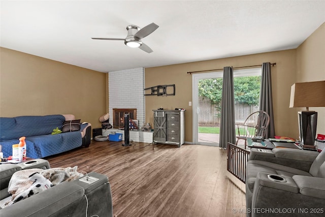 7630 E 54th Pl, Tulsa, OK 74145 - living room featuring a ceiling fan, wood finished floors, and a fireplace