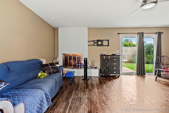 7630 E 54th Pl, Tulsa, OK 74145 - living area featuring wood finished floors, ceiling fan, and a brick fireplace