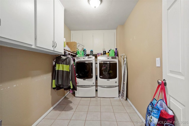 7630 E 54th Pl, Tulsa, OK 74145 - laundry area with cabinet space, washer and clothes dryer, and light tile patterned floors
