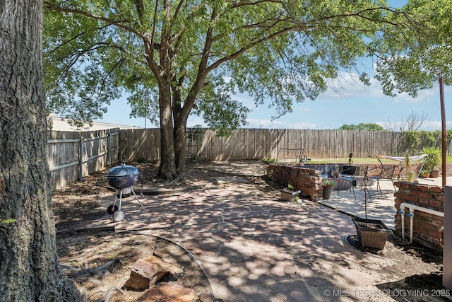 6717 E 99th St, Tulsa, OK 74133 - fenced backyard with a patio and area for grilling