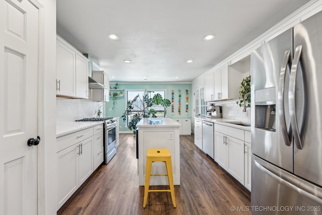 6717 E 99th St, Tulsa, OK 74133 - kitchen with appliances with stainless steel finishes, decorative backsplash, white cabinets, dark wood-style flooring, and recessed lighting