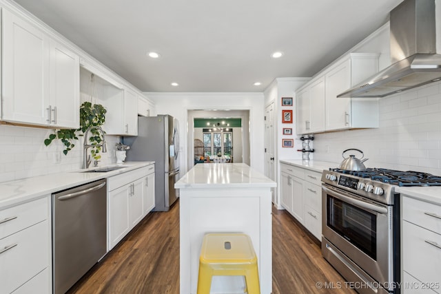 6717 E 99th St, Tulsa, OK 74133 - kitchen with stainless steel appliances, wall chimney range hood, a sink, white cabinets, and recessed lighting