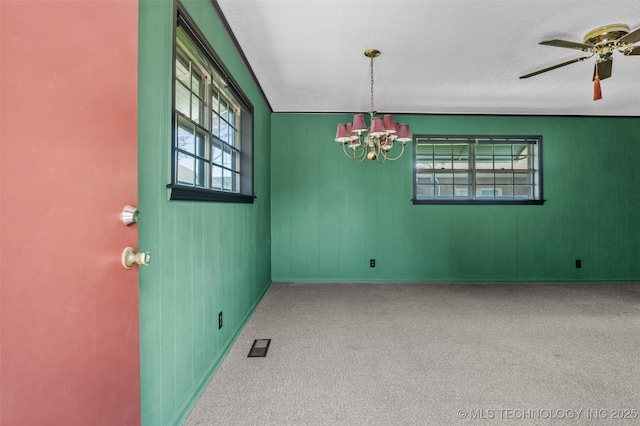 2728 E 13th Pl, Tulsa, OK 74104 - empty room featuring a chandelier, carpet, and ceiling fan