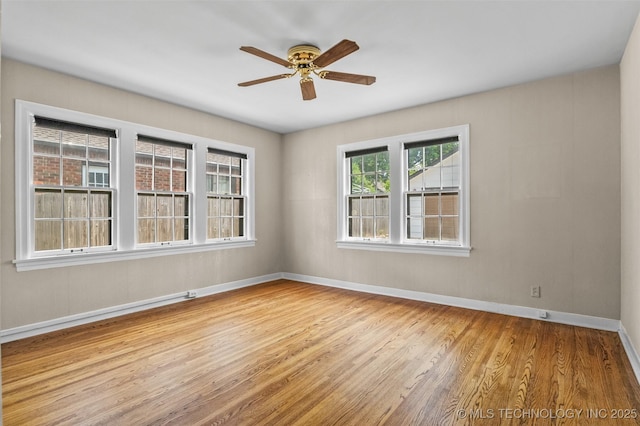 2728 E 13th Pl, Tulsa, OK 74104 - unfurnished room featuring wood finished floors, a ceiling fan, and baseboards