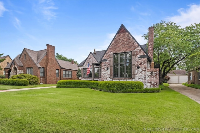 2728 E 13th Pl, Tulsa, OK 74104 - tudor house with brick siding, a front lawn, and a chimney
