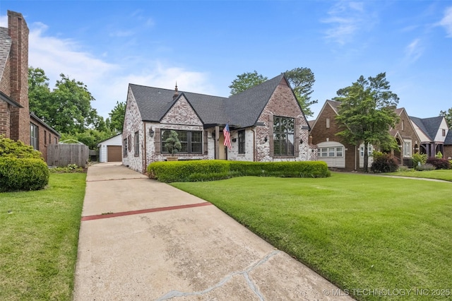 2728 E 13th Pl, Tulsa, OK 74104 - view of front of home with brick siding, a garage, and an outdoor structure