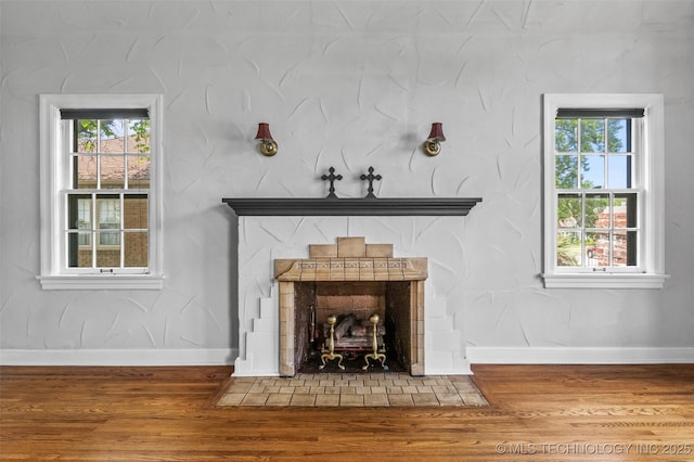 2728 E 13th Pl, Tulsa, OK 74104 - detailed view of a fireplace with flush hearth, wood finished floors, and baseboards