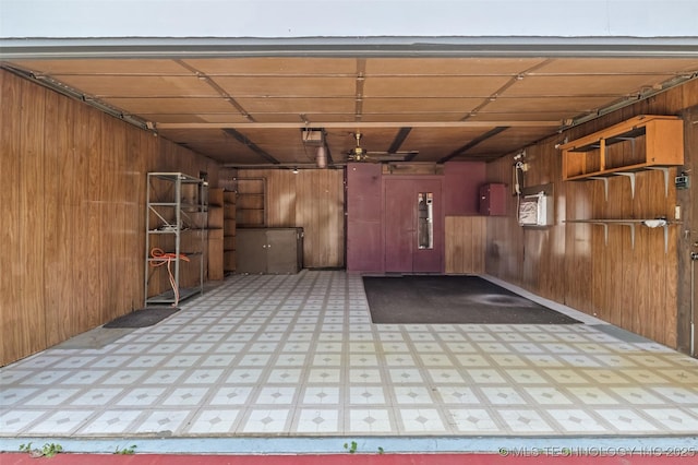 2728 E 13th Pl, Tulsa, OK 74104 - garage with wood walls, a ceiling fan, and electric panel