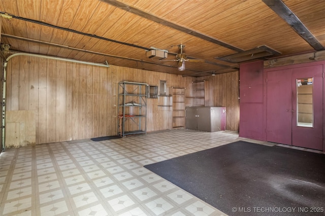 2728 E 13th Pl, Tulsa, OK 74104 - garage featuring a garage door opener, wooden walls, wood ceiling, and ceiling fan