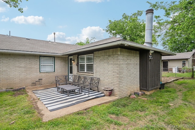 2761 S 134th E Ave, Tulsa, OK 74134 - back of property featuring brick siding, roof with shingles, and a patio area