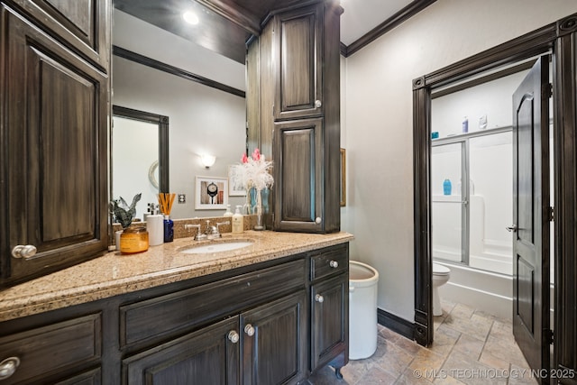 9914 S Garnett Rd, Broken Arrow, OK 74012 - full bath with toilet, stone tile floors, vanity, crown molding, and shower / bath combination with glass door