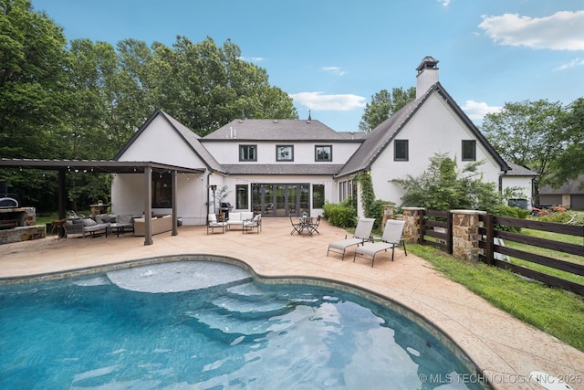 9914 S Garnett Rd, Broken Arrow, OK 74012 - back of property featuring an outdoor hangout area, stucco siding, an outdoor pool, and a chimney