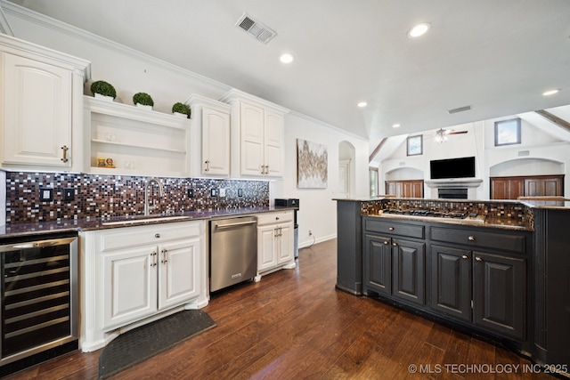 9914 S Garnett Rd, Broken Arrow, OK 74012 - kitchen featuring wine cooler, stainless steel appliances, dark countertops, white cabinets, and ceiling fan