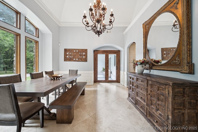9914 S Garnett Rd, Broken Arrow, OK 74012 - dining space with a chandelier, french doors, arched walkways, a towering ceiling, and crown molding