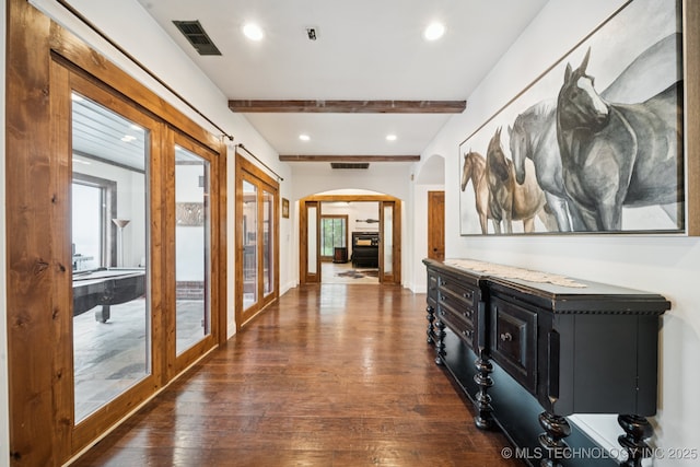 9914 S Garnett Rd, Broken Arrow, OK 74012 - hall featuring arched walkways, dark wood-style flooring, beamed ceiling, recessed lighting, and french doors