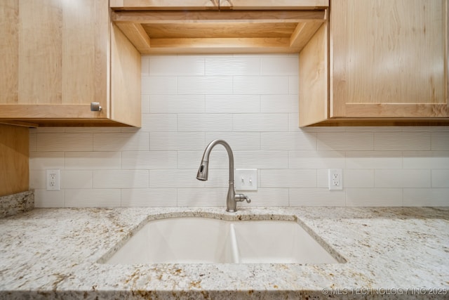 8216 S Oswego Ave, Tulsa, OK 74137 - kitchen featuring a sink, decorative backsplash, and light stone counters