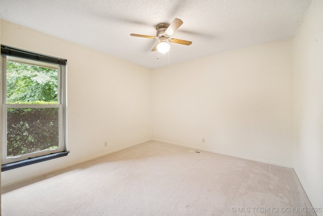 8216 S Oswego Ave, Tulsa, OK 74137 - spare room featuring carpet, a ceiling fan, a textured ceiling, and baseboards