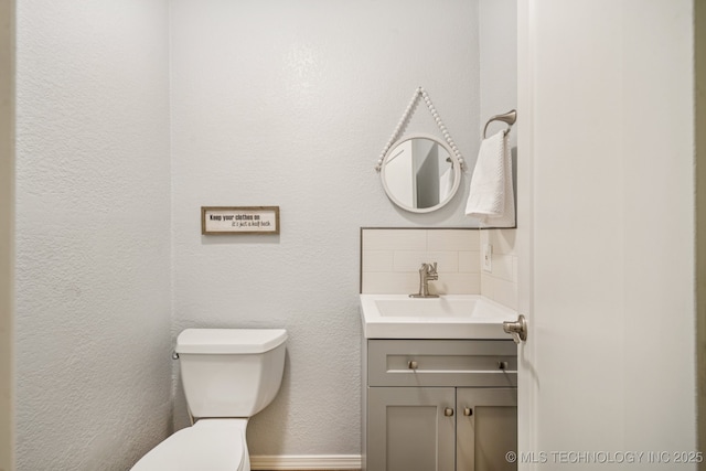 8216 S Oswego Ave, Tulsa, OK 74137 - half bath with toilet, vanity, baseboards, and backsplash