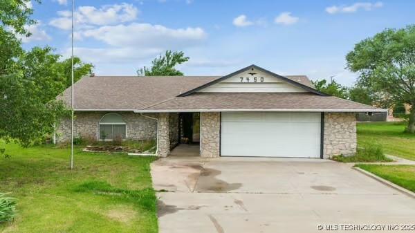 7450 N 117th E Ave, Owasso, OK 74055 - view of front facade featuring stone siding, driveway, an attached garage, and a front yard