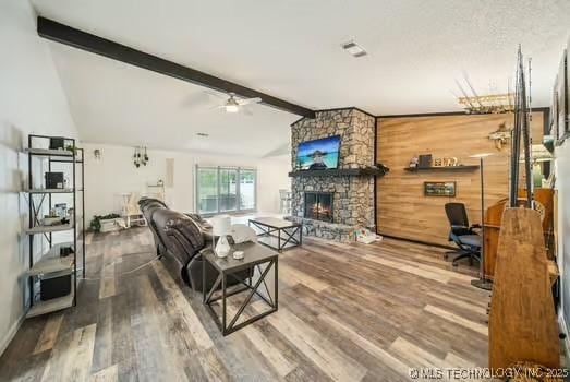 7450 N 117th E Ave, Owasso, OK 74055 - living room featuring a fireplace, wood finished floors, a ceiling fan, and wooden walls