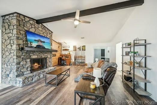 7450 N 117th E Ave, Owasso, OK 74055 - living room with a fireplace, wood finished floors, and ceiling fan