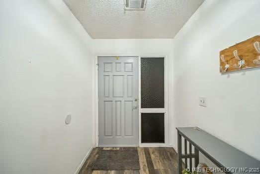 7450 N 117th E Ave, Owasso, OK 74055 - entrance foyer featuring wood finished floors, a textured ceiling, and baseboards