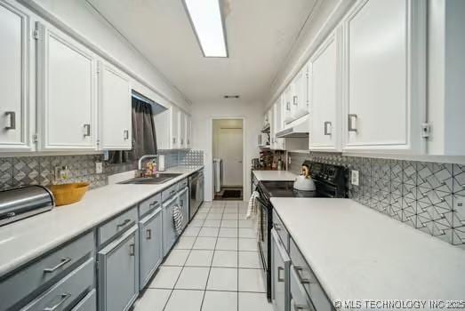 7450 N 117th E Ave, Owasso, OK 74055 - kitchen with electric range, a sink, gray cabinets, light tile patterned floors, and under cabinet range hood