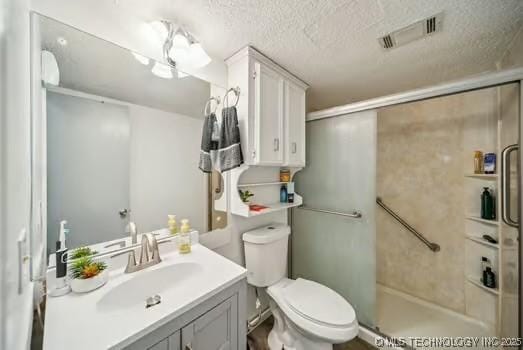 7450 N 117th E Ave, Owasso, OK 74055 - bathroom with vanity, a shower, toilet, and a textured ceiling