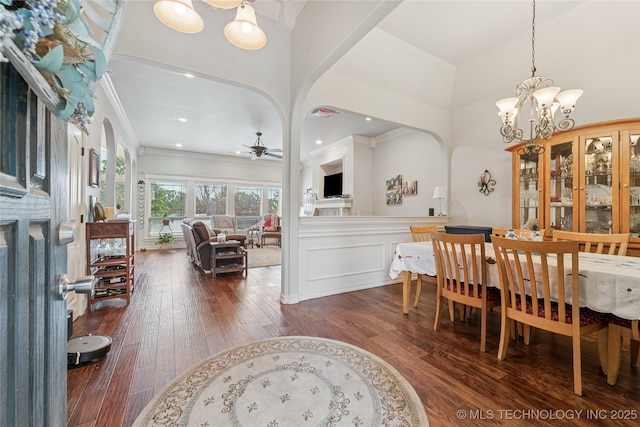 2508 S 14th St, Mcalester, OK 74501 - dining room with arched walkways, a chandelier, a ceiling fan, wood-type flooring, and crown molding