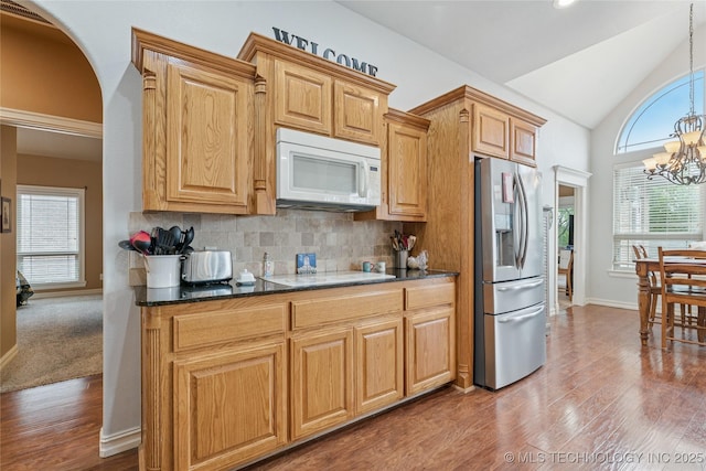 2508 S 14th St, Mcalester, OK 74501 - kitchen with white appliances, plenty of natural light, wood finished floors, and lofted ceiling