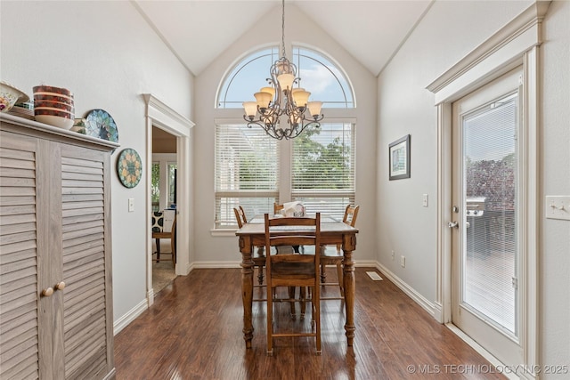 2508 S 14th St, Mcalester, OK 74501 - dining room featuring dark wood-style floors, a chandelier, vaulted ceiling, and baseboards