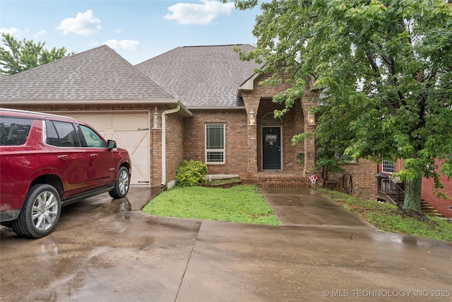 2508 S 14th St, Mcalester, OK 74501 - view of front of property with an attached garage, asphalt driveway, brick siding, and a shingled roof