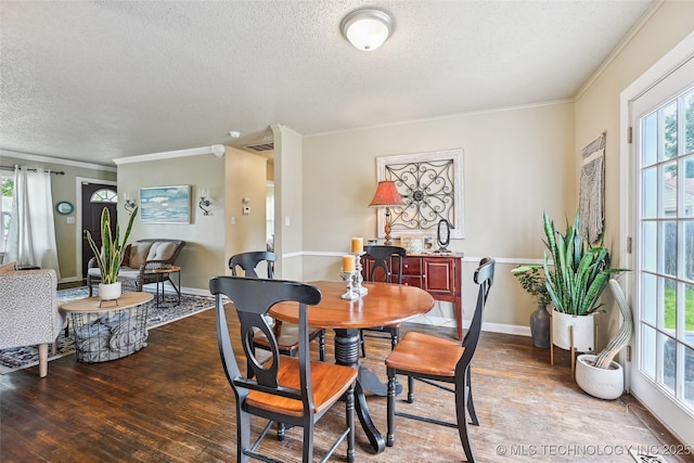 3508 E 30th St, Tulsa, OK 74114 - dining space with a textured ceiling, crown molding, wood finished floors, and baseboards