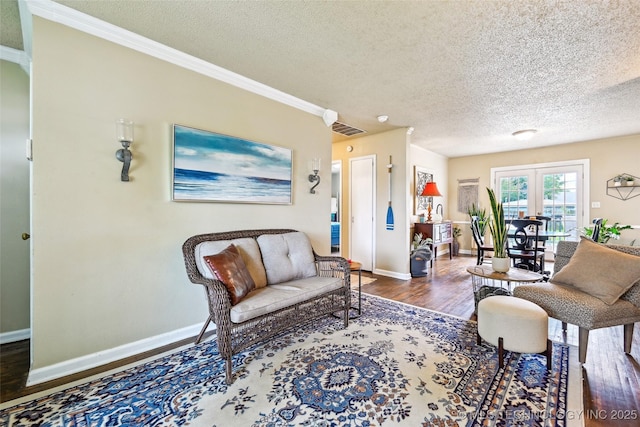 3508 E 30th St, Tulsa, OK 74114 - living area featuring wood finished floors, a textured ceiling, baseboards, and crown molding
