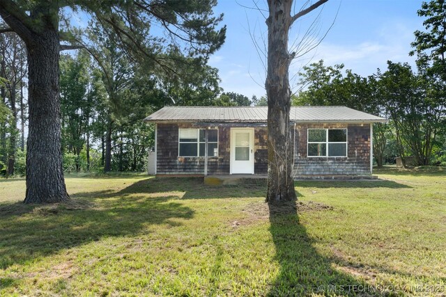 5164 Smiser Rd, Calera, OK 74730 - view of front of house featuring a front lawn and metal roof