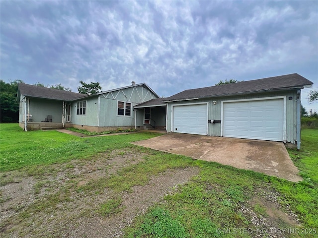 5006 S 449th Ave W, Jennings, OK 74038 - back of property featuring driveway, a lawn, and a garage