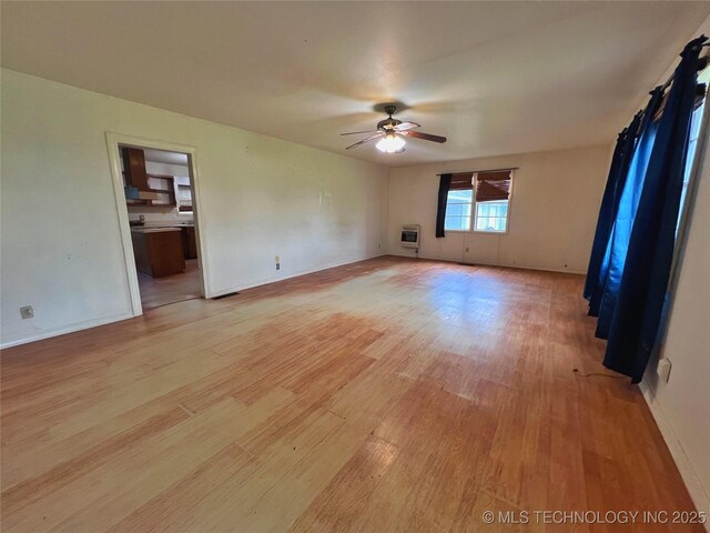 5006 S 449th Ave W, Jennings, OK 74038 - unfurnished room featuring light wood-style flooring, a ceiling fan, heating unit, and baseboards