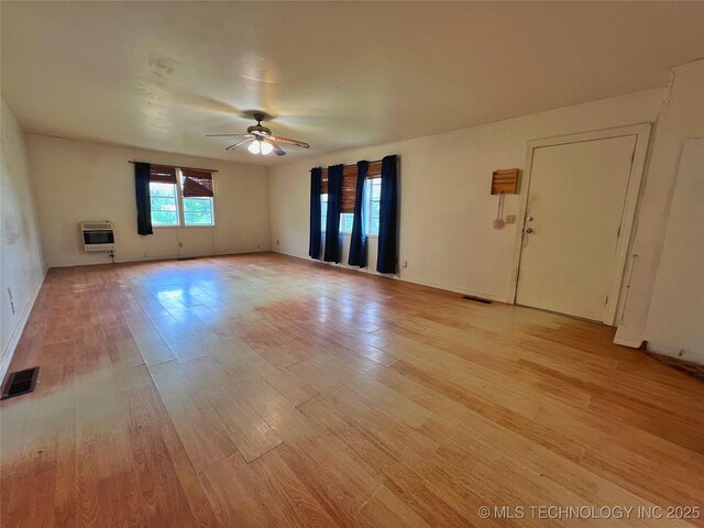 5006 S 449th Ave W, Jennings, OK 74038 - unfurnished living room with light wood-type flooring, ceiling fan, and heating unit