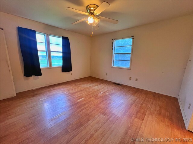 5006 S 449th Ave W, Jennings, OK 74038 - unfurnished room with light wood-style flooring, ceiling fan, and baseboards