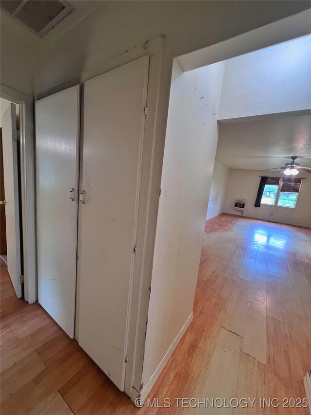 5006 S 449th Ave W, Jennings, OK 74038 - hallway featuring light wood finished floors and a wall mounted air conditioner