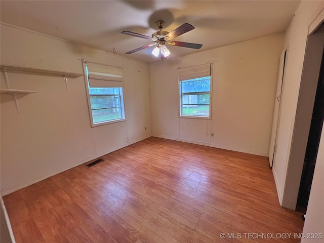 5006 S 449th Ave W, Jennings, OK 74038 - spare room featuring plenty of natural light, light wood-style floors, a ceiling fan, and baseboards