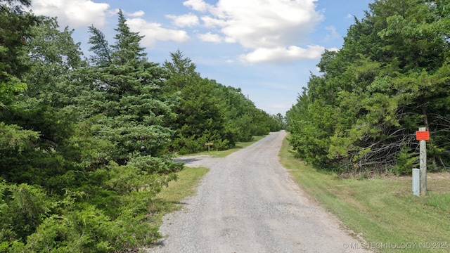 2018 Baker Dr, Mannford, OK 74044 - view of dirt / gravel road with a view of trees