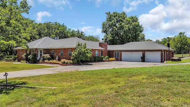7023 Myall Rd, Lone Grove, OK 73443 - view of front of property with a chimney, driveway, a garage, brick siding, and a front lawn