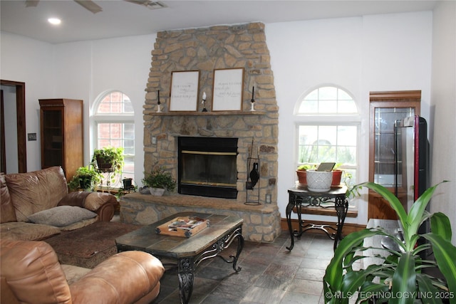 7023 Myall Rd, Lone Grove, OK 73443 - living area with plenty of natural light, a stone fireplace, and stone finish floors
