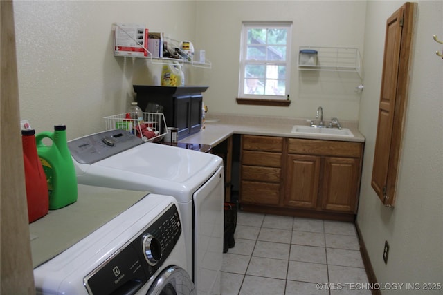 7023 Myall Rd, Lone Grove, OK 73443 - laundry area featuring washer and clothes dryer, cabinet space, and light tile patterned floors