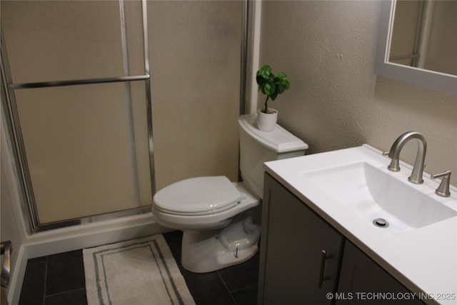 7023 Myall Rd, Lone Grove, OK 73443 - full bath featuring toilet, tile patterned floors, vanity, a textured wall, and a shower with shower door