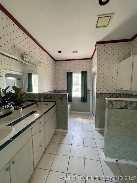 7023 Myall Rd, Lone Grove, OK 73443 - bathroom featuring ornamental molding, wallpapered walls, double vanity, a garden tub, and a shower stall