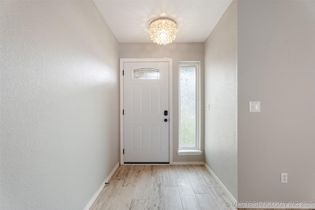 1802 S Fir Pl, Broken Arrow, OK 74012 - entryway featuring a chandelier, a textured wall, light wood-style floors, and baseboards