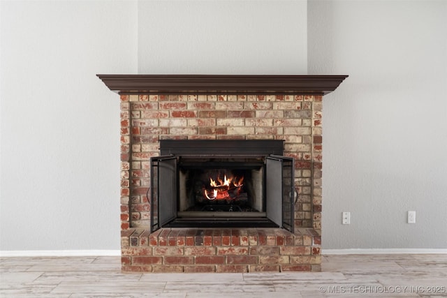 1802 S Fir Pl, Broken Arrow, OK 74012 - detailed view of a fireplace, wood finished floors, and baseboards